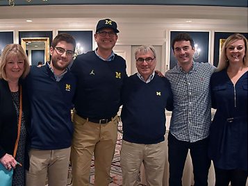 Jim Burnstein poses with his family and Coach Harbaugh after the screening 